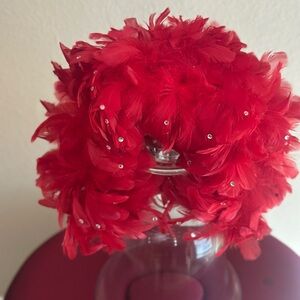Vibrant red feather headband with scattered rhinestones in front